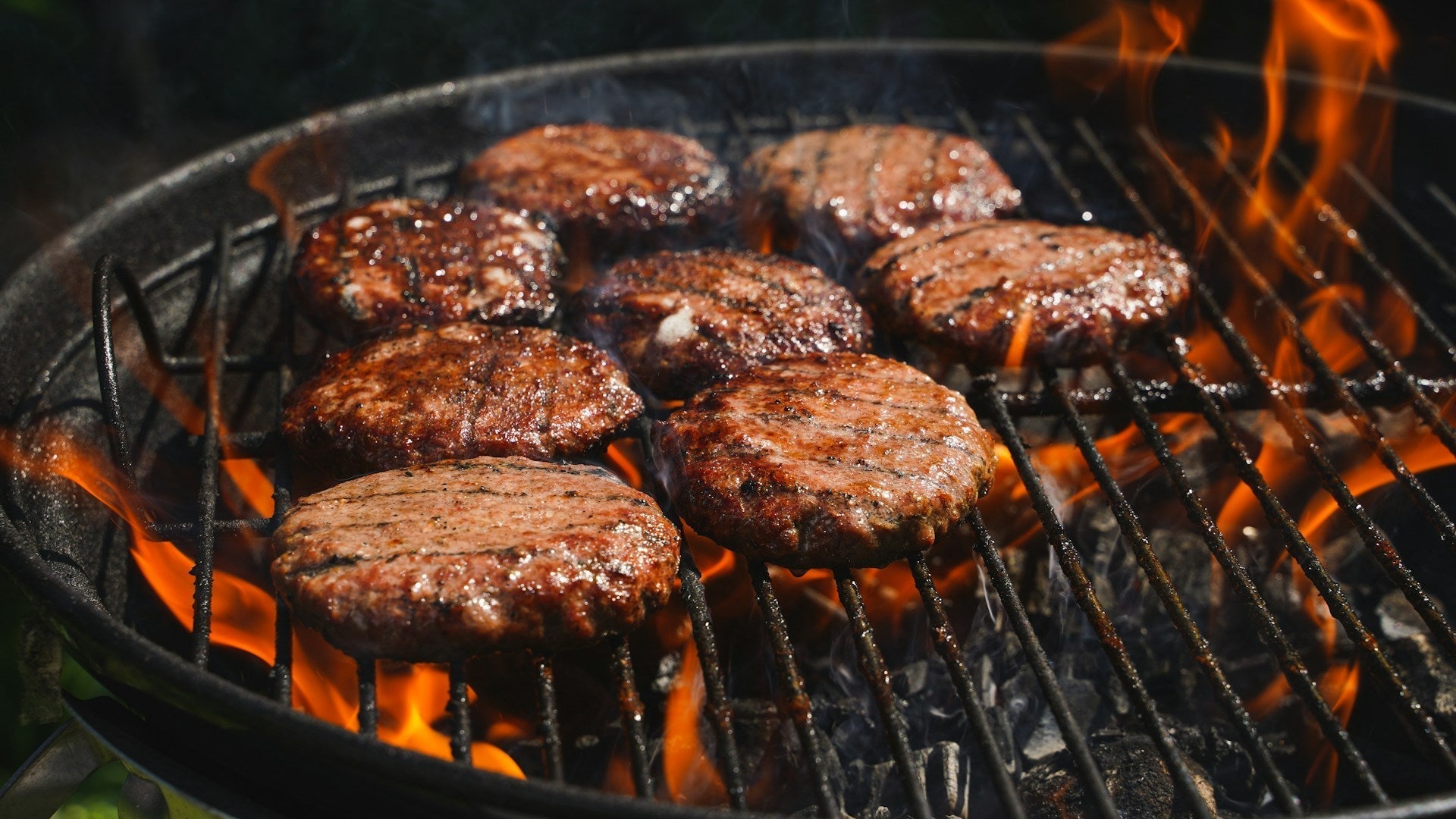 Burgers cooking on a grill
