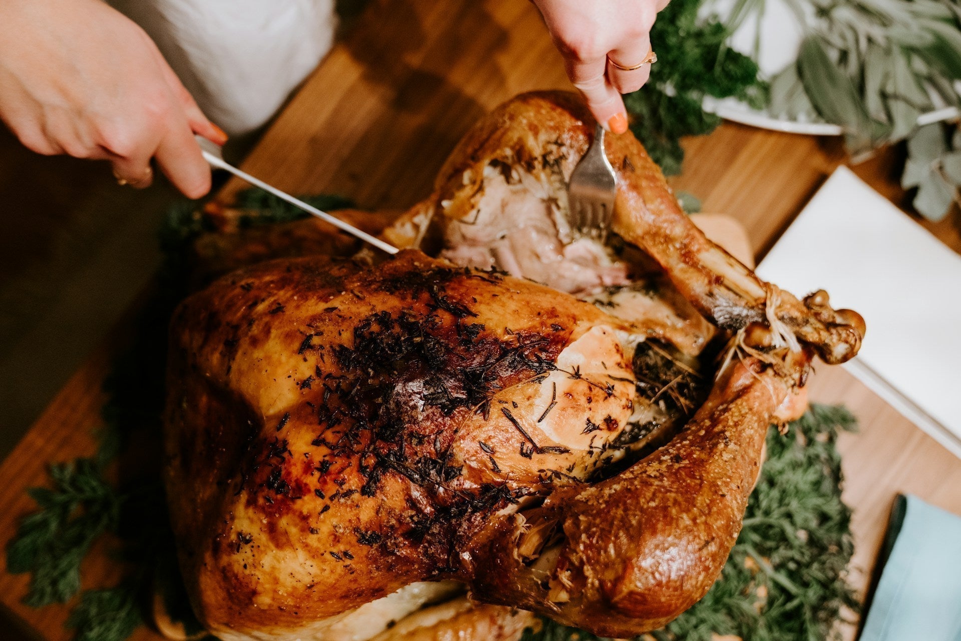 person slicing roasted turkey