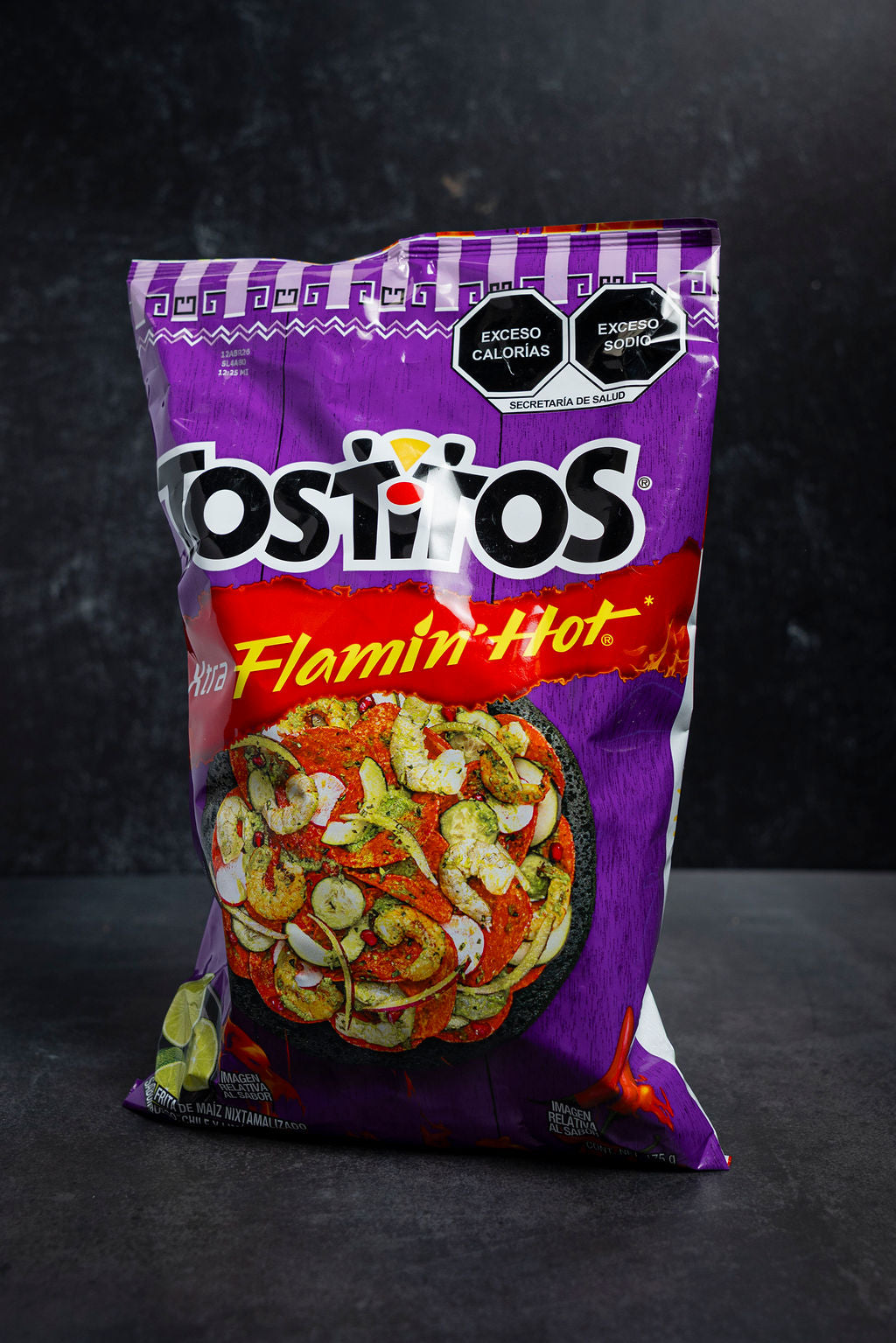 Tostitos Flamin' Hot chip bag on a dark background