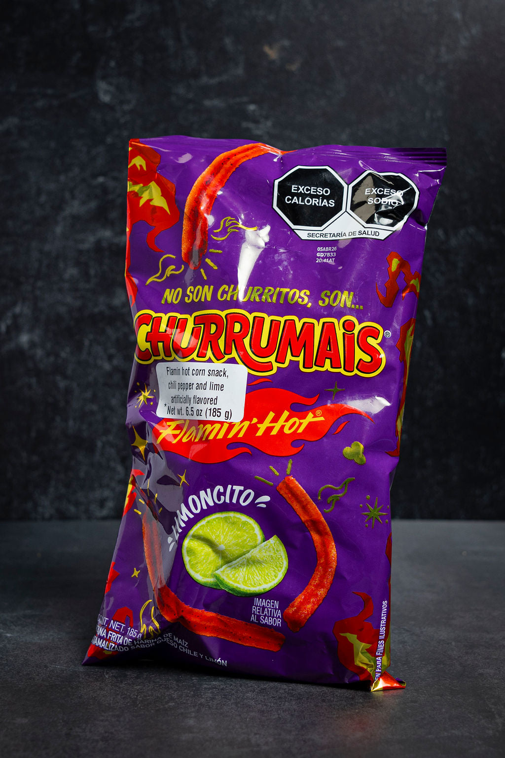 Purple bag of Churrumais hot corn snacks on a dark background