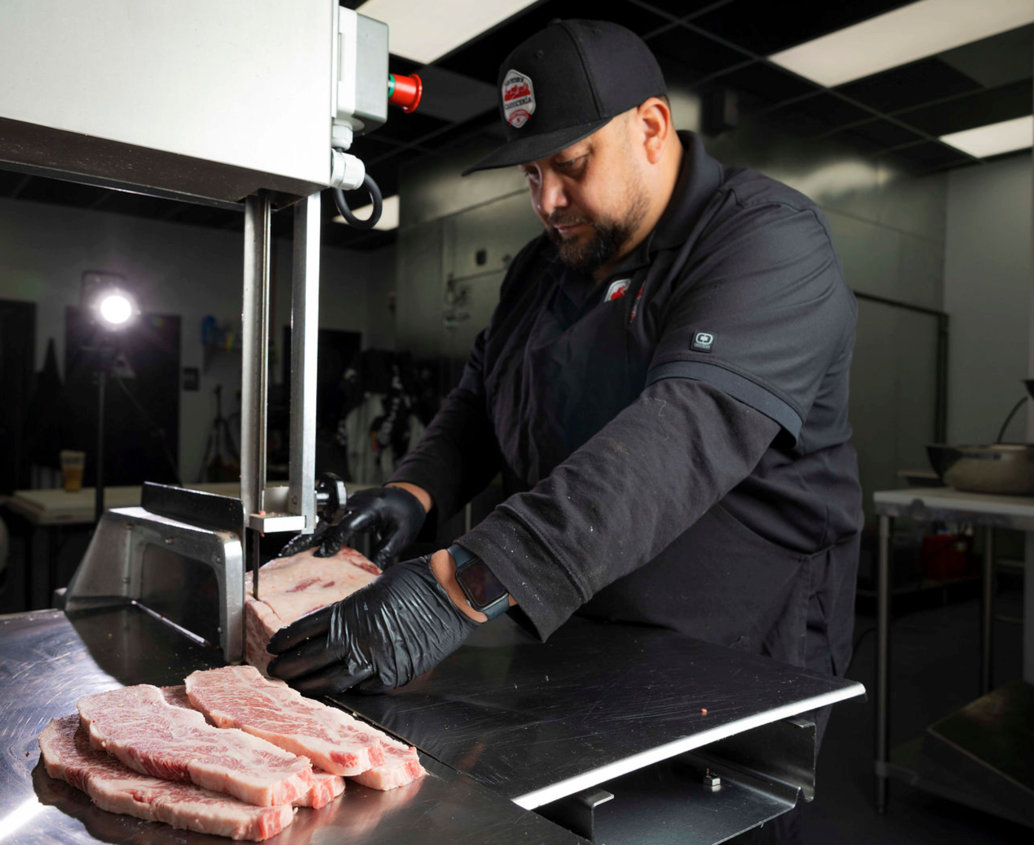 a butcher leaning on a table with raw meat
