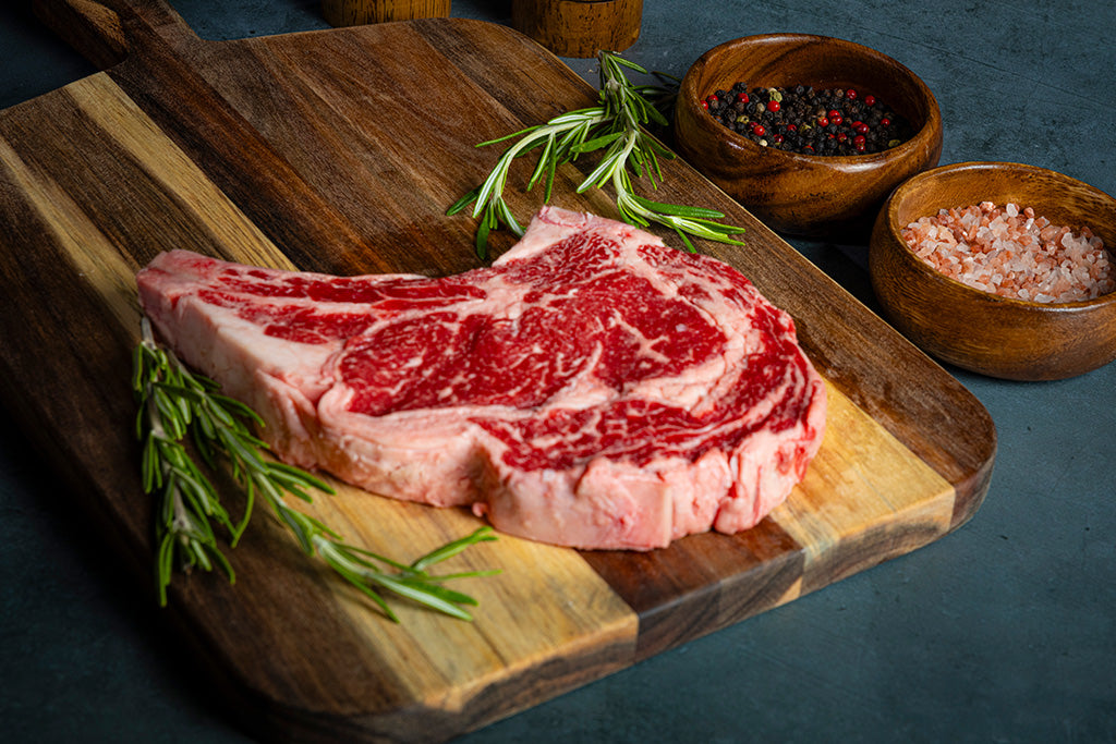 USDA prime beef steak on a wooden cutting board